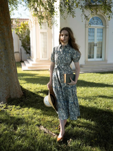a lady wears a floral printed lapel tiered midi dress